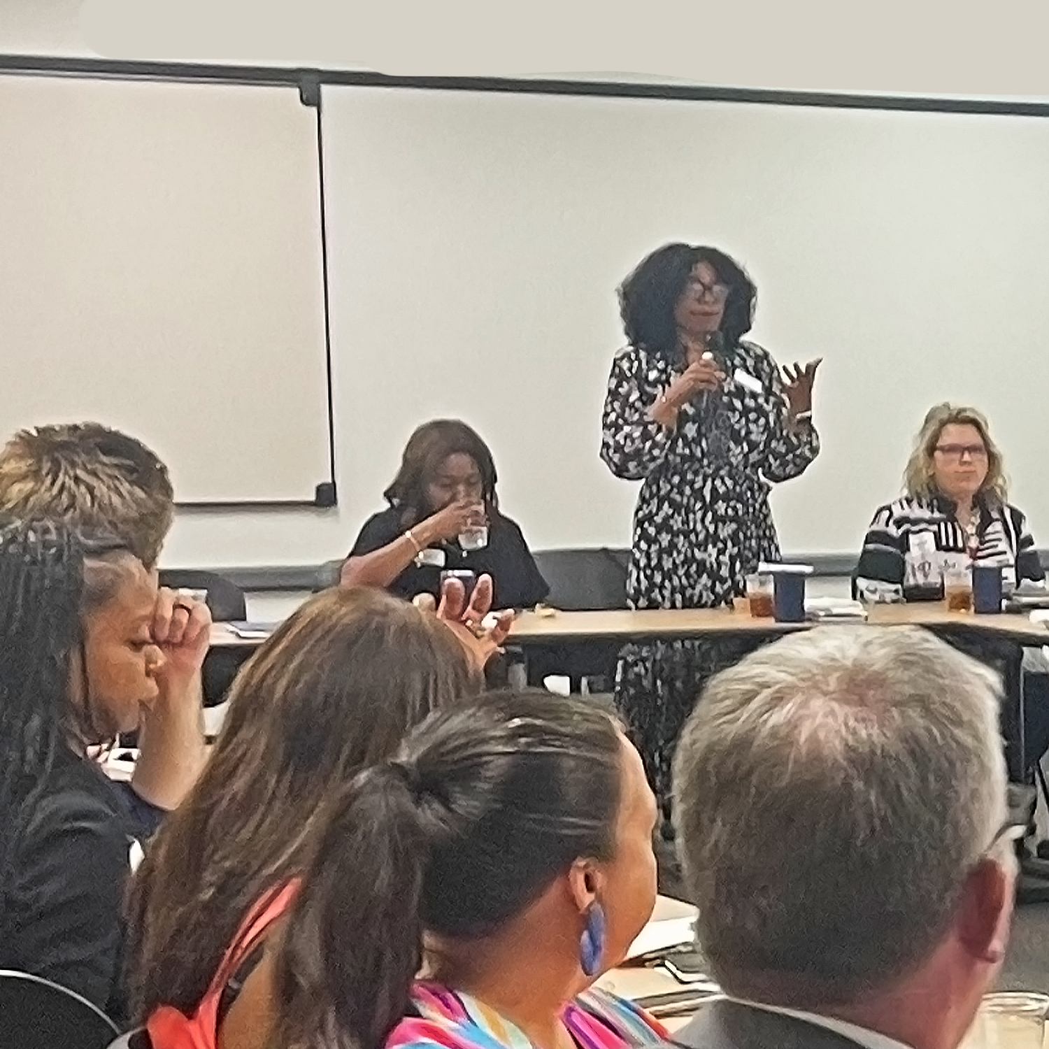 Attendee stands to introduce a topic of discussion