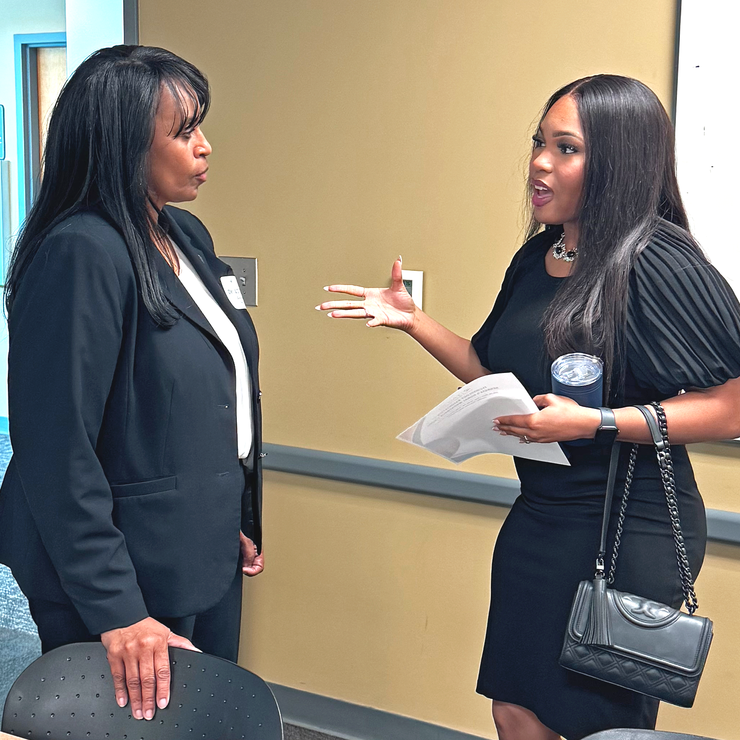 Attendee discusses forum topics with Dr. Loretta Daniels